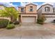 Charming two-story home with a two car garage, well maintained lawn, and attractive desert landscaping at 1562 W Lacewood Pl, Phoenix, AZ 85045