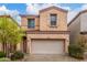 Inviting home with a two-car garage, with manicured bushes and desert landscaping adding to curb appeal at 1562 W Lacewood Pl, Phoenix, AZ 85045