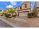 Well-maintained home featuring a two-car garage, lush landscaping, and a welcoming curb appeal at 1562 W Lacewood Pl, Phoenix, AZ 85045