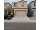 Two-story home featuring a well maintained lawn, a large 2-car garage, and desert landscaping at 1562 W Lacewood Pl, Phoenix, AZ 85045