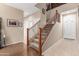 Inviting foyer featuring a staircase with decorative iron railing and neutral color palette at 1562 W Lacewood Pl, Phoenix, AZ 85045