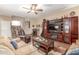 Living area showcasing a plush couch, entertainment center, and seamlessly connected staircase at 1562 W Lacewood Pl, Phoenix, AZ 85045