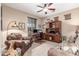 Comfortable home office featuring a ceiling fan, natural light, and a functional workspace at 1562 W Lacewood Pl, Phoenix, AZ 85045