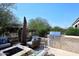 The backyard features a built-in outdoor kitchen, perfect for entertaining with plenty of seating near a fire pit at 16935 W Cambridge Ave, Goodyear, AZ 85395