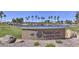 Scenic view of the PebbleCreek community entrance sign amidst a picturesque landscape with lush greenery and mature trees at 16935 W Cambridge Ave, Goodyear, AZ 85395