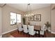 Bright dining room with hardwood floors, stylish chairs, and view of the outdoor patio at 16935 W Cambridge Ave, Goodyear, AZ 85395