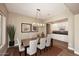 Elegant dining room with modern chandelier, stylish chairs, and wine bar at 16935 W Cambridge Ave # 57, Goodyear, AZ 85395