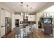 Bright kitchen with stainless steel appliances, a large island, and modern finishes at 16935 W Cambridge Ave, Goodyear, AZ 85395