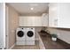 Functional laundry room with modern appliances, ample cabinet space, and a sink at 16935 W Cambridge Ave, Goodyear, AZ 85395