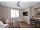 Cozy living room with a modern ceiling fan, hardwood floors, and a comfortable seating arrangement at 16935 W Cambridge Ave, Goodyear, AZ 85395