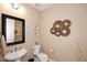 Elegant powder room featuring a pedestal sink, decorative wall art, and modern fixtures at 16935 W Cambridge Ave, Goodyear, AZ 85395