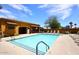 Outdoor swimming pool by building with lounge chairs, perfect for relaxation and enjoying the sun at 16935 W Cambridge Ave, Goodyear, AZ 85395