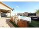 Outdoor kitchen and grilling area overlooking a pool and lounge space in the backyard at 1713 W Cottonwood Ln, Phoenix, AZ 85045