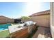 Built-in outdoor kitchen and grill next to a beautiful pool and lounge area at 1713 W Cottonwood Ln, Phoenix, AZ 85045