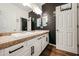 Bathroom featuring double sinks, framed mirrors, modern lighting and wood-look flooring at 1713 W Cottonwood Ln, Phoenix, AZ 85045