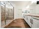 Large bathroom featuring a glass walk-in shower and double sink vanity with storage at 1713 W Cottonwood Ln, Phoenix, AZ 85045