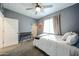 Cozy bedroom with carpet flooring, ceiling fan, and natural light at 1713 W Cottonwood Ln, Phoenix, AZ 85045