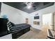 Cozy bedroom featuring a ceiling fan, sleek black ceiling, and a motivational decor at 1713 W Cottonwood Ln, Phoenix, AZ 85045