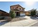 Two-story home features a two car garage and low maintenance desert landscaping at 1713 W Cottonwood Ln, Phoenix, AZ 85045