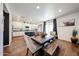 Spacious kitchen with island flows into a dining area with rustic wood table and seating at 1713 W Cottonwood Ln, Phoenix, AZ 85045