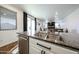 Close-up of a kitchen island with stainless steel dishwasher, granite countertops, and a double bowl sink at 1713 W Cottonwood Ln, Phoenix, AZ 85045