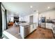 A modern, open-concept kitchen with stainless steel appliances and a large center island flows into the living and dining area at 1713 W Cottonwood Ln, Phoenix, AZ 85045