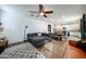 Open-concept living room and kitchen with tile flooring, comfortable seating, and a ceiling fan at 1713 W Cottonwood Ln, Phoenix, AZ 85045