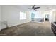 Bright loft area with plush carpeting, a ceiling fan, and plenty of natural light at 1713 W Cottonwood Ln, Phoenix, AZ 85045