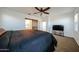 Well-lit main bedroom featuring a sliding barn door and plush carpet at 1713 W Cottonwood Ln, Phoenix, AZ 85045