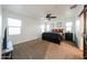 Spacious main bedroom features large windows, a ceiling fan, and plush carpet at 1713 W Cottonwood Ln, Phoenix, AZ 85045