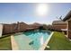 An expansive pool area with seating, umbrellas, artificial turf, and a clear blue swimming pool at 1713 W Cottonwood Ln, Phoenix, AZ 85045