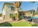 Expansive backyard featuring a pergola, a built-in television, outdoor seating, lush landscaping, and a pool area at 17751 W Bloomfield Rd, Surprise, AZ 85388