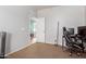 Bedroom showcasing neutral walls, carpet flooring, and an open doorway leading to a bright, connected living space at 17751 W Bloomfield Rd, Surprise, AZ 85388