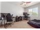 Spacious bedroom featuring neutral walls, carpet flooring, two desk areas, and bright natural light at 17751 W Bloomfield Rd, Surprise, AZ 85388