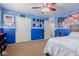 Cozy bedroom featuring blue walls, carpet flooring, sliding door closet, and ceiling fan at 17751 W Bloomfield Rd, Surprise, AZ 85388