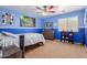 Bright bedroom with blue walls, carpet flooring, ceiling fan, and decor at 17751 W Bloomfield Rd, Surprise, AZ 85388