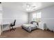 Neutral bedroom with carpet flooring, ceiling fan, desk, and a bed at 17751 W Bloomfield Rd, Surprise, AZ 85388