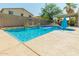 Sparkling pool featuring rock waterfalls, lush greenery, and a tranquil water fountain providing a serene ambiance at 17751 W Bloomfield Rd, Surprise, AZ 85388