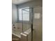 Bathroom featuring a bathtub with glass shower doors and chrome fixtures at 18642 W Yucatan Dr, Surprise, AZ 85388