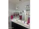 Bathroom with double sinks, granite countertops, and modern lighting fixtures at 18642 W Yucatan Dr, Surprise, AZ 85388