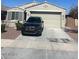 Front exterior showcasing a two-car garage and well-maintained landscaping at 18642 W Yucatan Dr, Surprise, AZ 85388