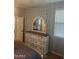 Main bedroom featuring a dresser with mirror and a window providing natural light at 18642 W Yucatan Dr, Surprise, AZ 85388