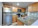 Bright kitchen with stainless steel refrigerator and microwave, and light wood cabinets at 200 E Southern Ave # 316, Tempe, AZ 85282