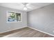 This bedroom offers wood floors, a ceiling fan, neutral paint, and a window with views at 2026 E Duke Dr, Tempe, AZ 85283