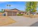 A well-kept single-Gathering house featuring a two-car garage, nice landscaping, and a tidy lawn at 2026 E Duke Dr, Tempe, AZ 85283