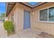 Charming entrance featuring a gray front door, brick accents, and manicured landscaping at 2026 E Duke Dr, Tempe, AZ 85283