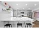 This bright kitchen features updated white cabinets, stone counters, and stainless appliances at 2026 E Duke Dr, Tempe, AZ 85283