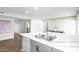 Open kitchen view with an island featuring a sink, floral wallpaper, and natural light at 2026 E Duke Dr, Tempe, AZ 85283