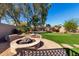 Relax in this backyard with a stone fire pit and putting green at 20640 N 100Th Ln, Peoria, AZ 85382