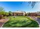 This backyard features a putting green, patio, and well-maintained landscaping at 20640 N 100Th Ln, Peoria, AZ 85382